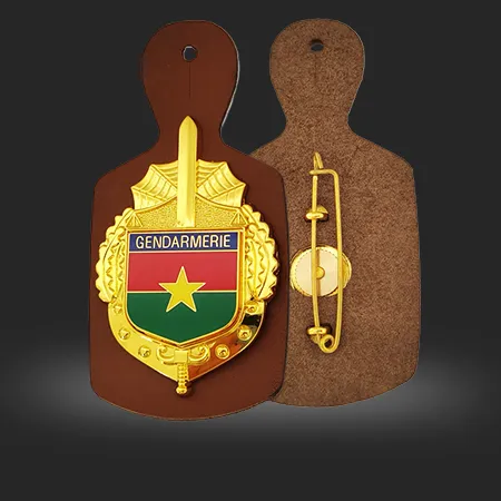 A metal shield-shaped badge mounted on a leather base, for the Cameroon police.