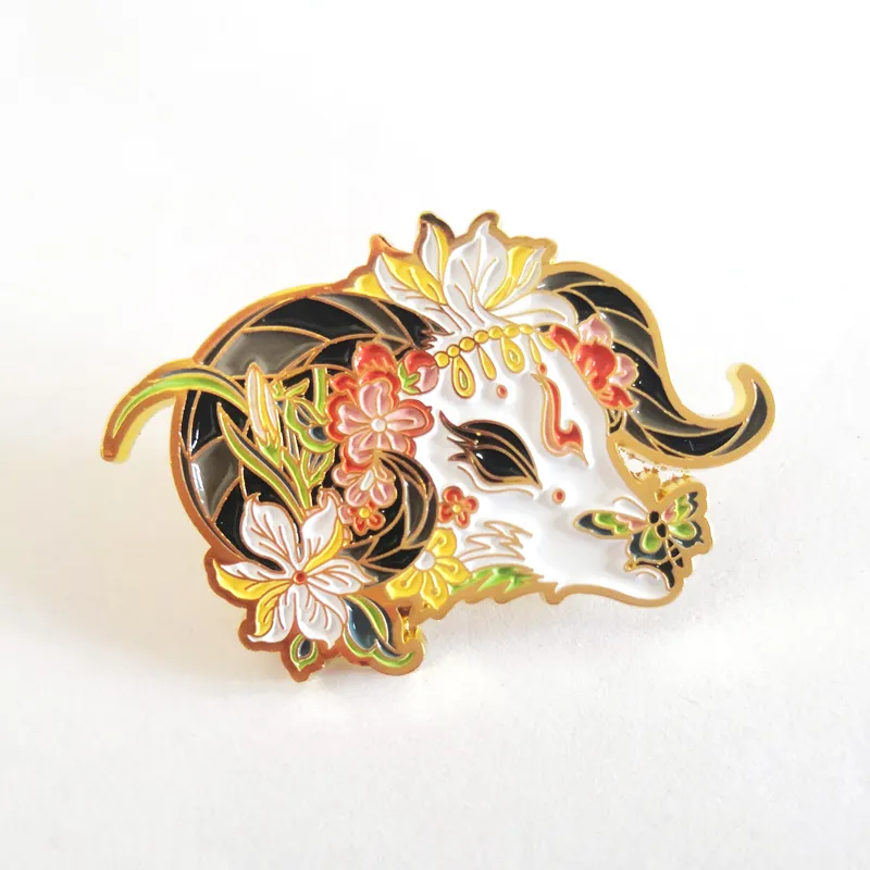 A lacquered enamel badge with a bull's head design