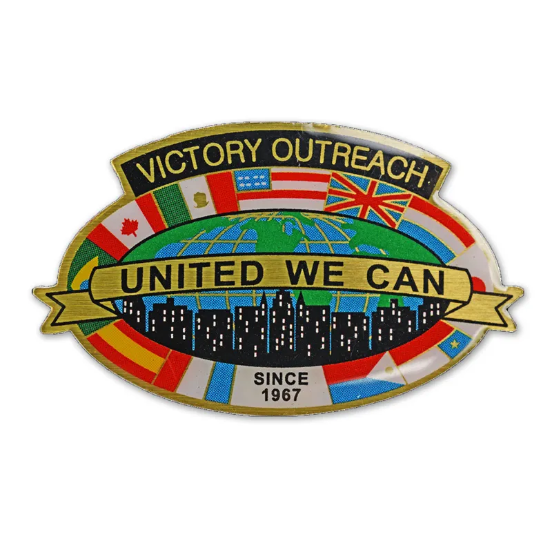 A "victory Outerach" themed badge brooch with a smooth epoxy resin coating on the surface.