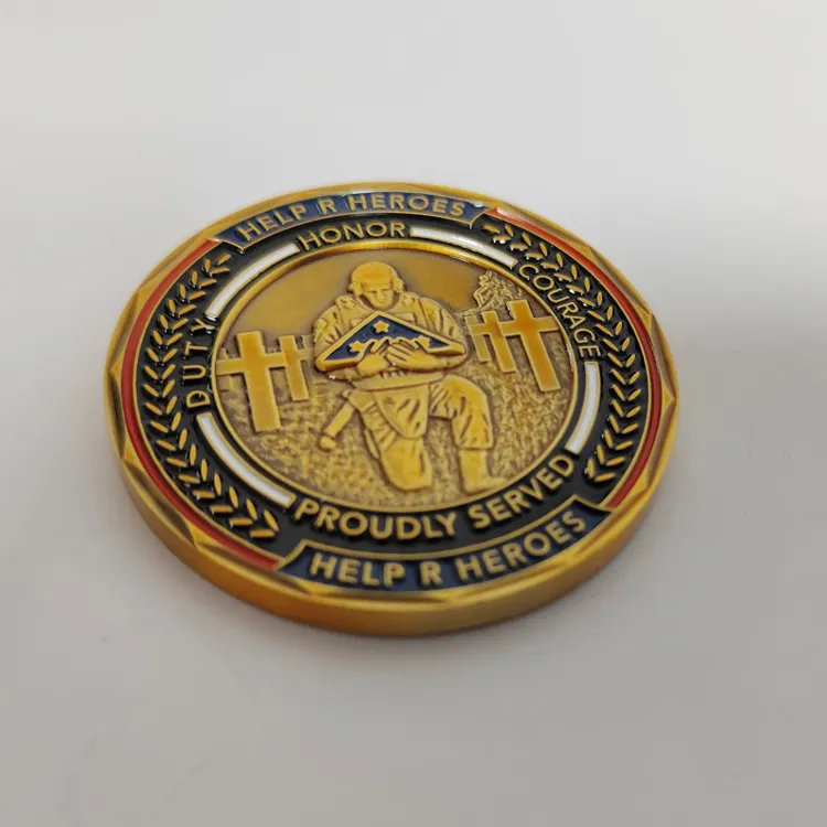 A circular challenge coin with a decorative border. The center depicts a soldier kneeling in front of cross-shaped headstones, surrounded by the words "HONOR," "COURAGE," "DUTY," and "PROUDLY SERVED.